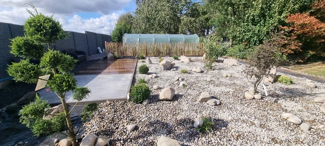 Les végétaux et les pierres rythment la perspective du jardin.