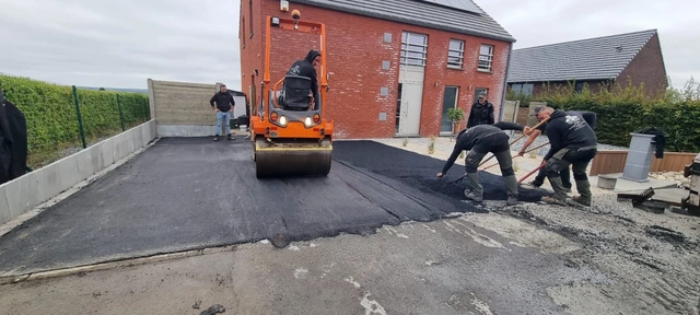 La mise en œuvre de l’asphalte et le passage du rouleau sur le parking.