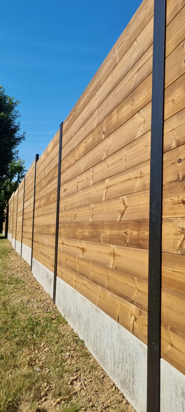 Clôture en bois à lames horizontales avec poteaux métalliques et soubassement en béton